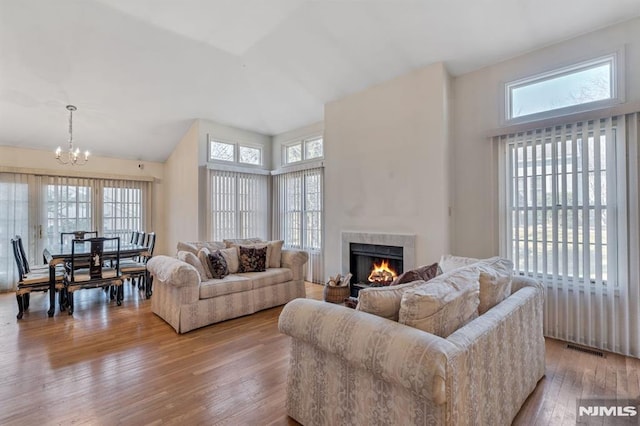 living room featuring a wealth of natural light, light wood-type flooring, and visible vents