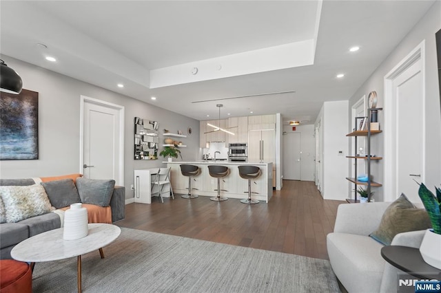 living area featuring dark wood-style floors and recessed lighting