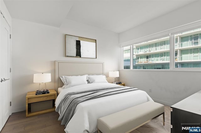 bedroom featuring baseboards and wood finished floors