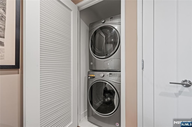 laundry room featuring laundry area and stacked washer / dryer