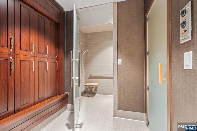 bathroom with a stall shower and tile patterned floors