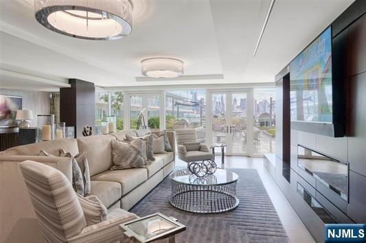 living area with french doors and a wall of windows