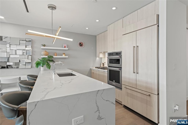 kitchen featuring stainless steel double oven, built in fridge, a sink, open shelves, and modern cabinets