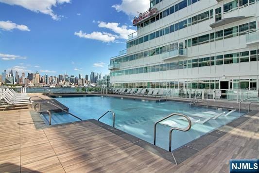 view of pool featuring a view of city