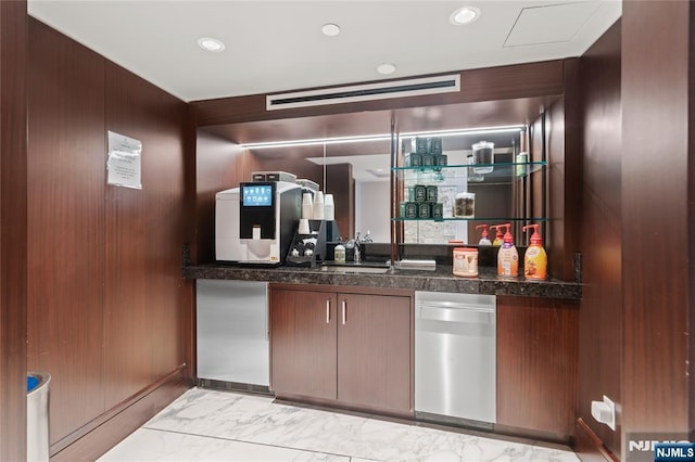 bar with marble finish floor, a bar, and recessed lighting