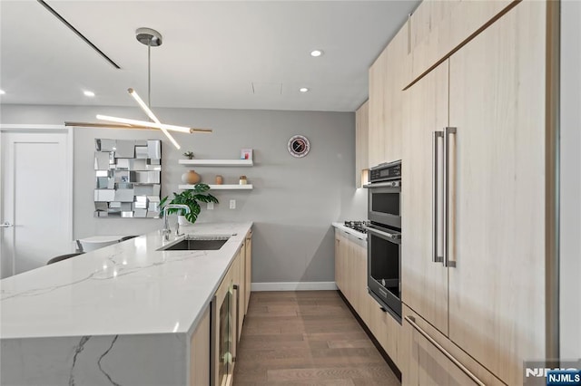 kitchen featuring modern cabinets, a sink, and light brown cabinetry