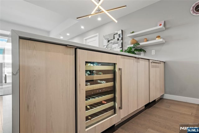 bar with wine cooler, baseboards, wood finished floors, and recessed lighting