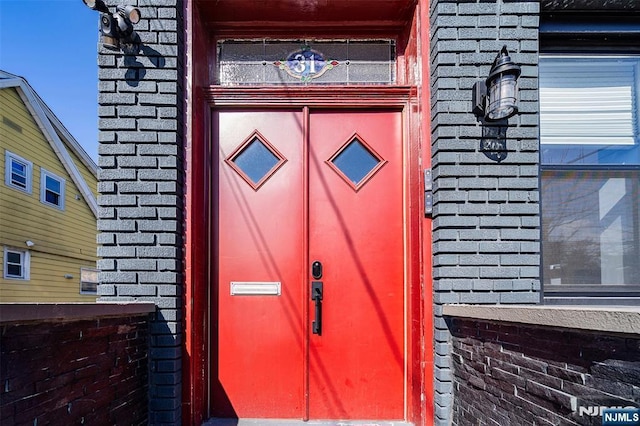 property entrance featuring brick siding