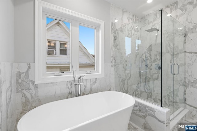 full bath featuring a soaking tub, marble finish floor, and a marble finish shower