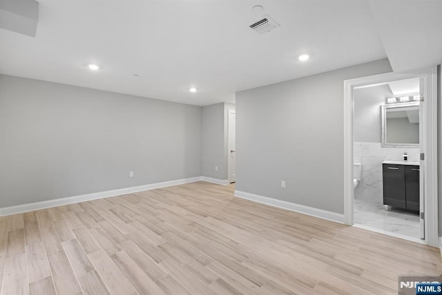 interior space with light wood-style flooring, visible vents, and recessed lighting