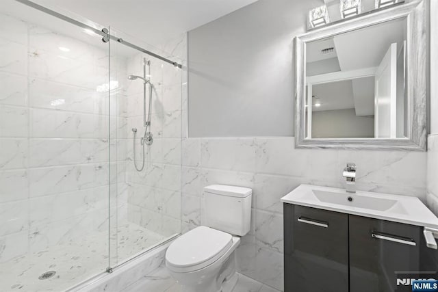 full bathroom featuring a marble finish shower, visible vents, toilet, marble finish floor, and vanity