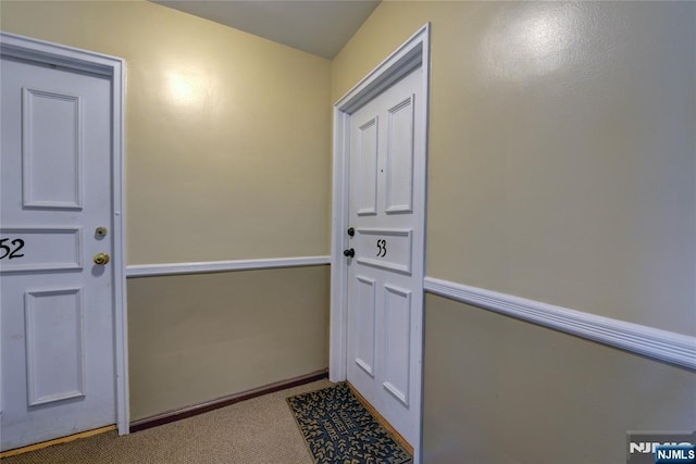 doorway to outside featuring carpet flooring