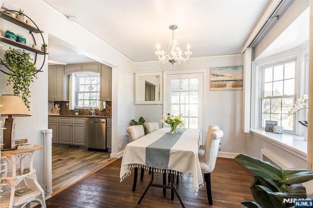 dining space with baseboards, a chandelier, and dark wood-style flooring