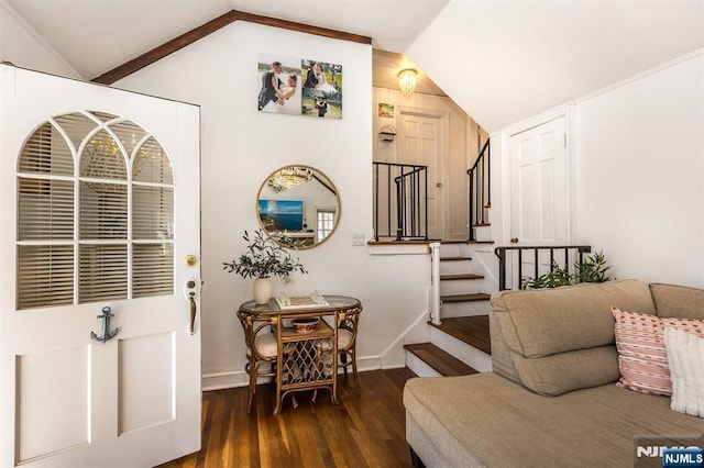 foyer entrance with lofted ceiling, baseboards, stairway, and wood finished floors