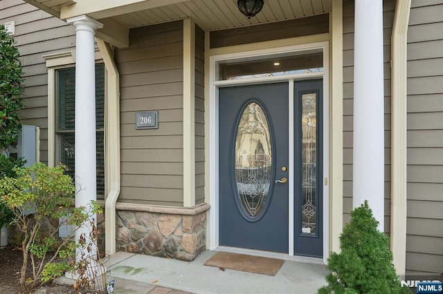 view of exterior entry featuring stone siding