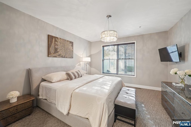 carpeted bedroom with an inviting chandelier and baseboards