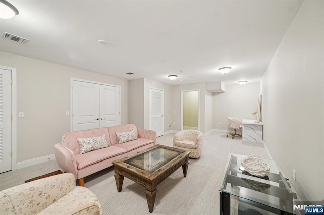 carpeted living room featuring baseboards and visible vents