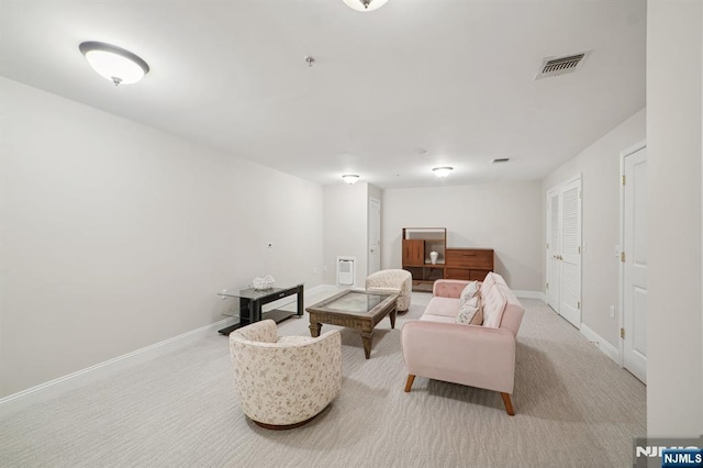 living room featuring carpet floors, visible vents, and baseboards