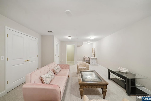 carpeted living area featuring baseboards and visible vents