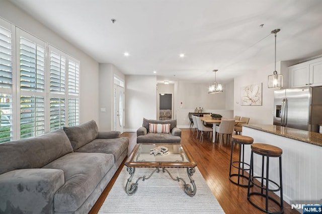 living area featuring recessed lighting, dark wood finished floors, and baseboards