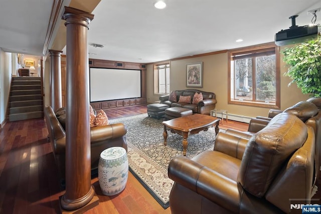 home theater room with a baseboard radiator, recessed lighting, visible vents, wood finished floors, and ornate columns