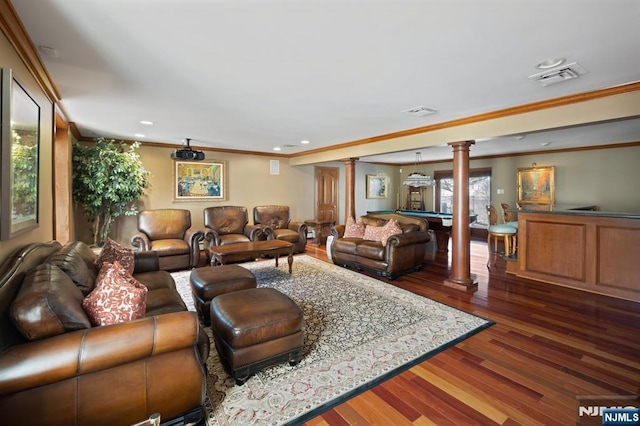 living area with dark wood finished floors, decorative columns, pool table, visible vents, and ornamental molding