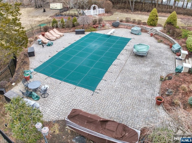 view of pool with a patio and fence