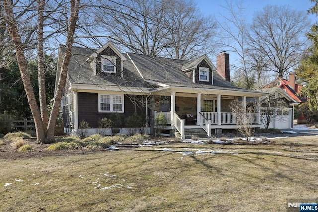 new england style home with a garage, a chimney, and a porch