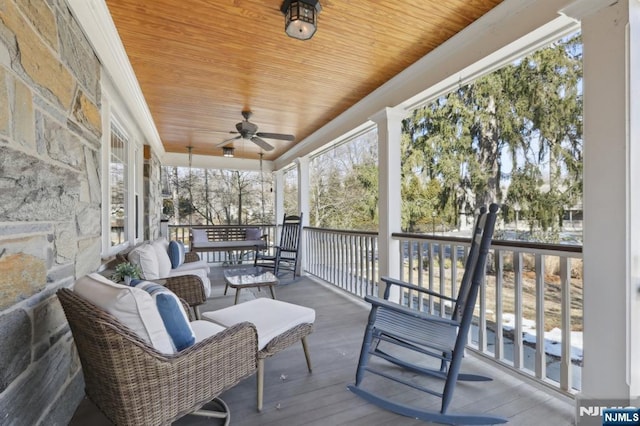 sunroom with wooden ceiling, plenty of natural light, and a ceiling fan