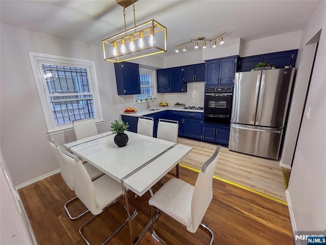 dining space with light wood-style floors and baseboards