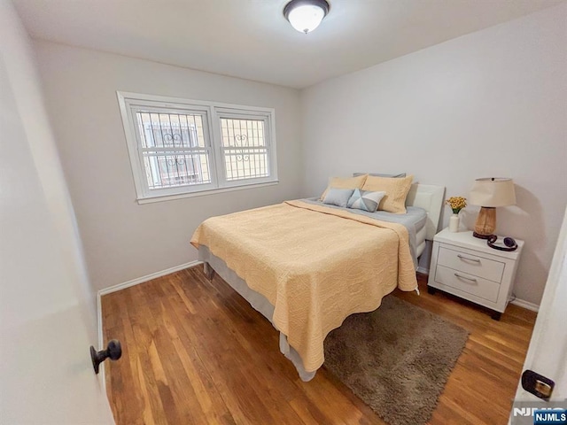 bedroom featuring light wood-type flooring and baseboards