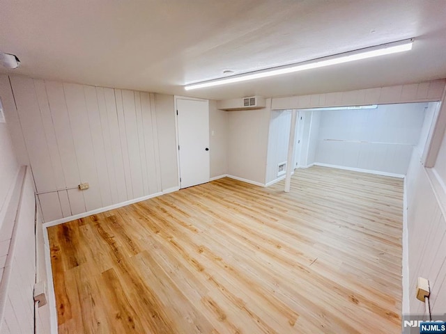 empty room with visible vents and wood finished floors