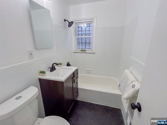 bathroom featuring  shower combination, vanity, toilet, and tile walls