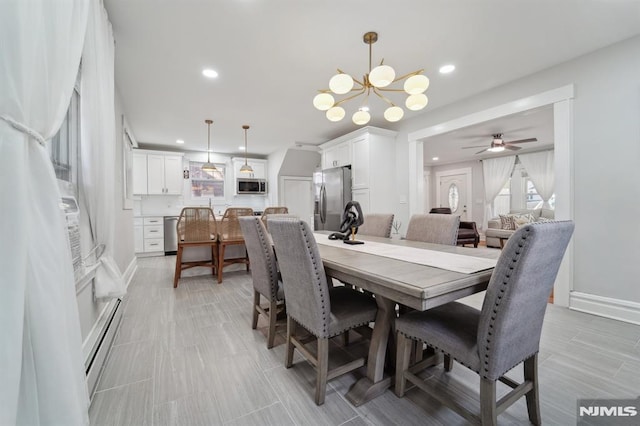 dining room with baseboards, ceiling fan with notable chandelier, a baseboard radiator, and recessed lighting