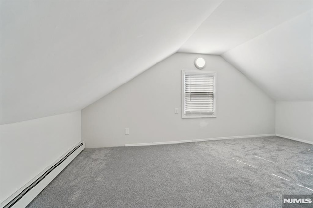 additional living space with lofted ceiling, carpet, baseboards, and baseboard heating