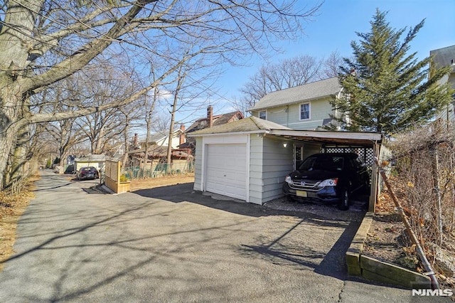 garage featuring aphalt driveway