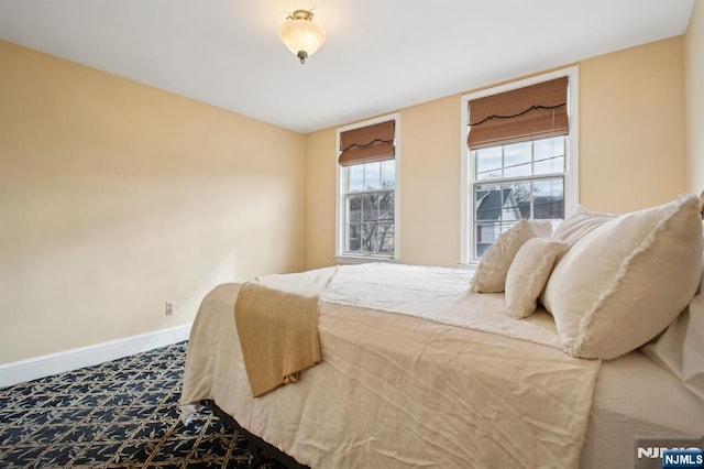 carpeted bedroom featuring baseboards