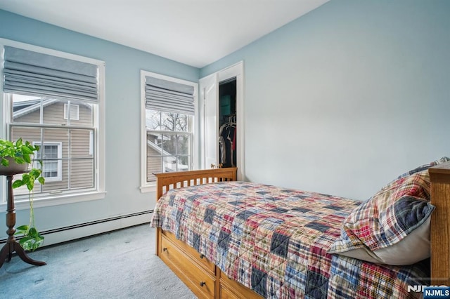 bedroom with carpet floors and a baseboard radiator