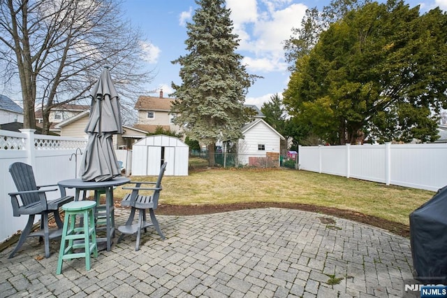 view of patio with a storage shed, grilling area, an outdoor structure, and a fenced backyard