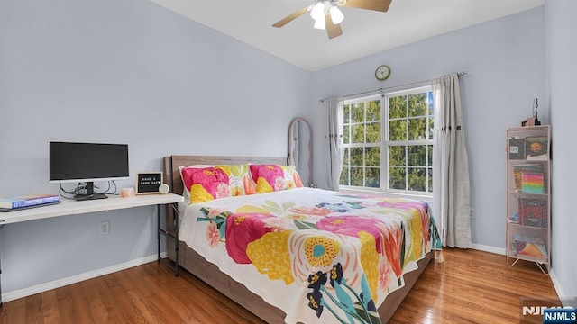 bedroom featuring ceiling fan, baseboards, and wood finished floors