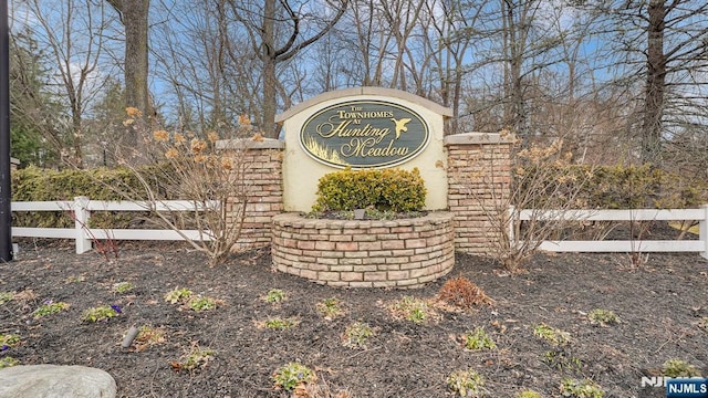 community / neighborhood sign with fence