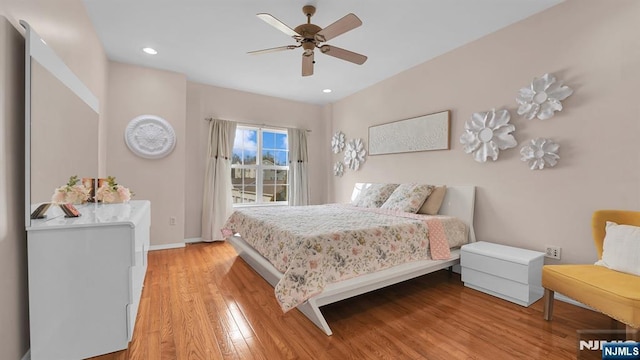 bedroom with access to exterior, light wood-style flooring, baseboards, and recessed lighting