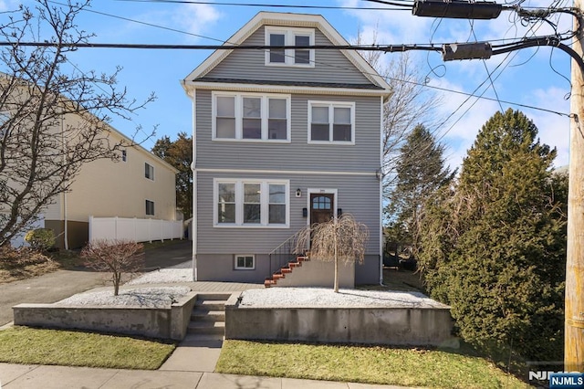 view of front of home featuring fence