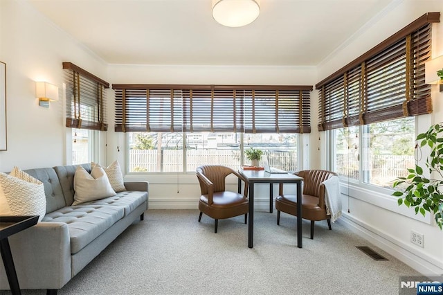 sunroom / solarium featuring a healthy amount of sunlight and visible vents