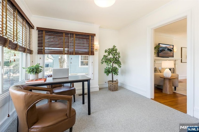 carpeted home office with ornamental molding and baseboards