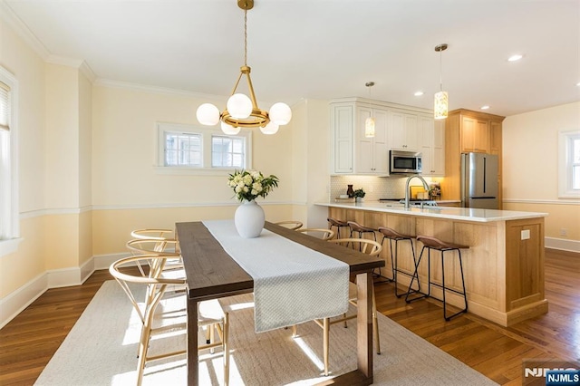 dining room featuring a wealth of natural light, dark wood finished floors, baseboards, and recessed lighting