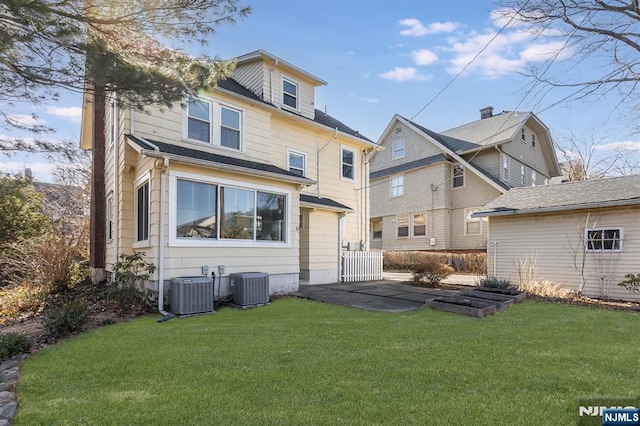 back of property featuring a patio, central AC, and a yard