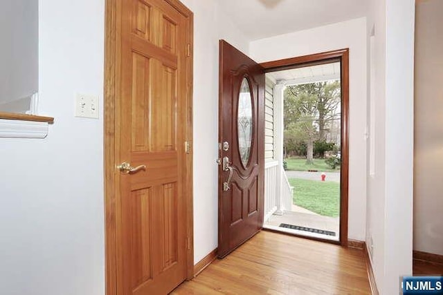 entryway featuring light wood-style flooring and baseboards