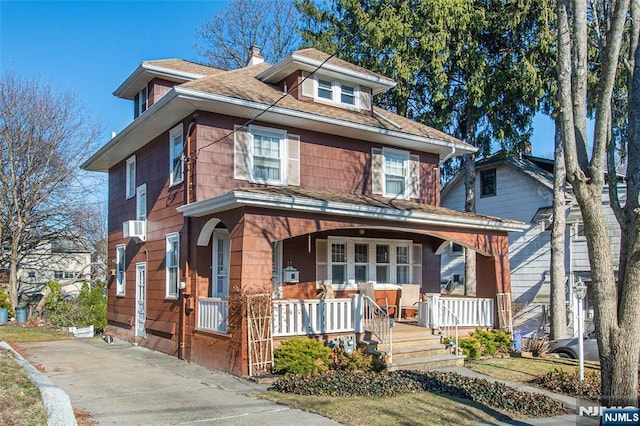 traditional style home with a chimney and a porch