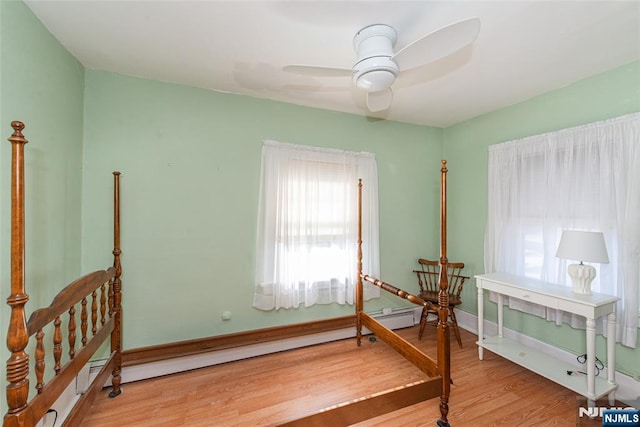 bedroom with baseboards and wood finished floors